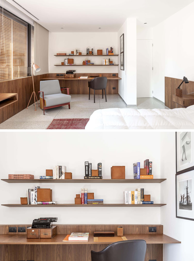 In this modern bedroom, there's a small home office area that features a wood desk and floating wood shelves. #HomeOffice #DeskIdeas #ModernShelving