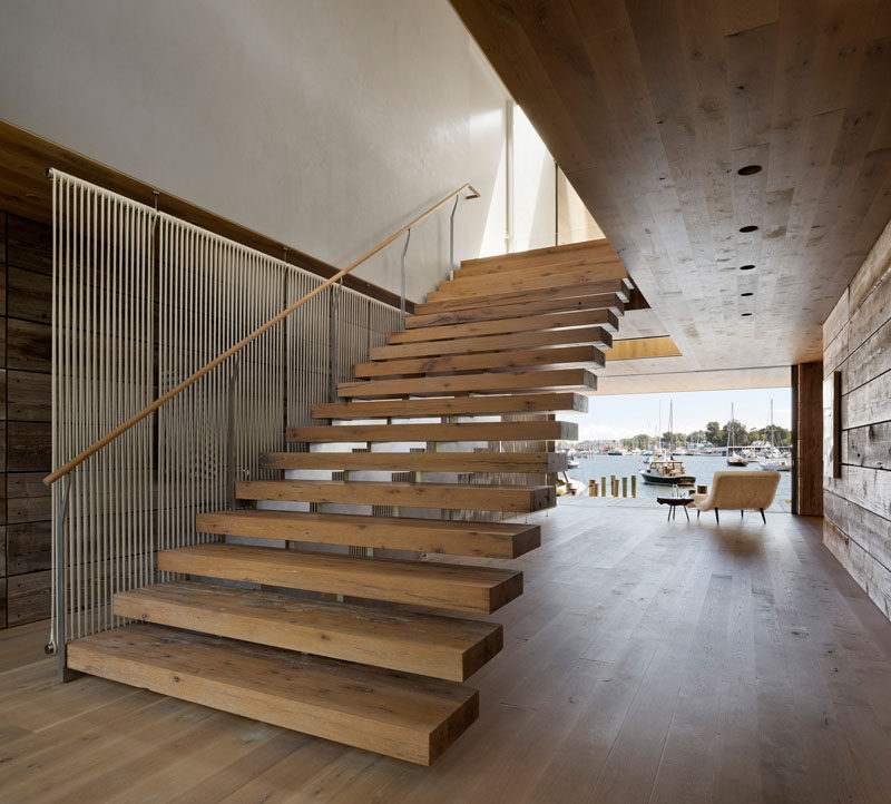 Wide wood stairs connect the ground level with the upper floor of this modern house, while adjacent to the stairs is a see-through screen made from rope that draws inspiration from local crafts and traditional materials. #WoodStairs #ModernStairs