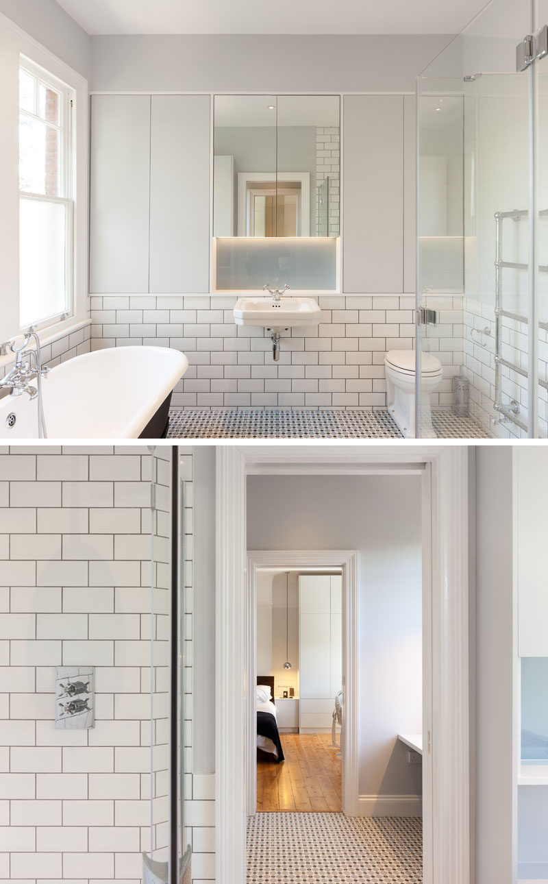 In this contemporary bathroom, white subway tiles with dark grout cover the walls, while a freestanding bathtub with a black exterior creates contrast. #ContemporaryBathroom #WhiteSubwayTiles