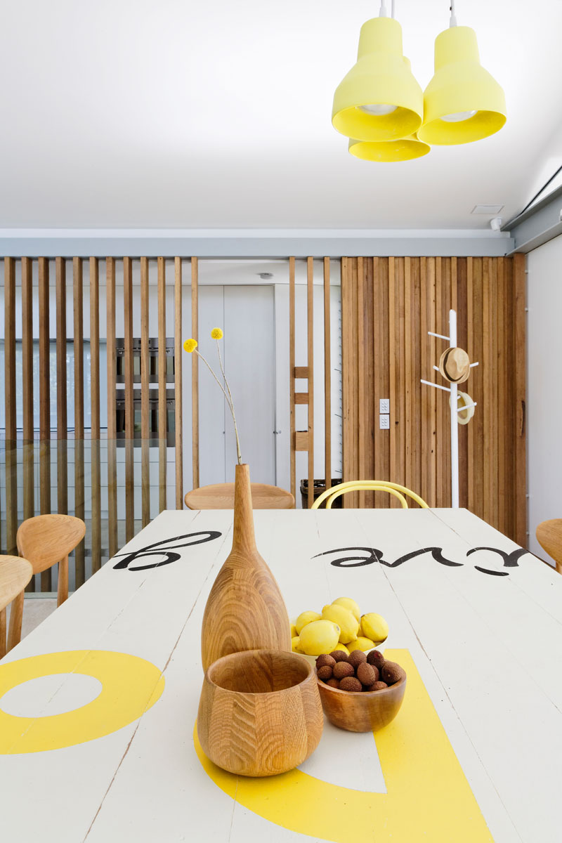 This modern dining area has pops of yellow to keep the interior bright with a sense of fun. #DiningRoom #YellowDecor #InteriorDesign #ModernDiningRoom