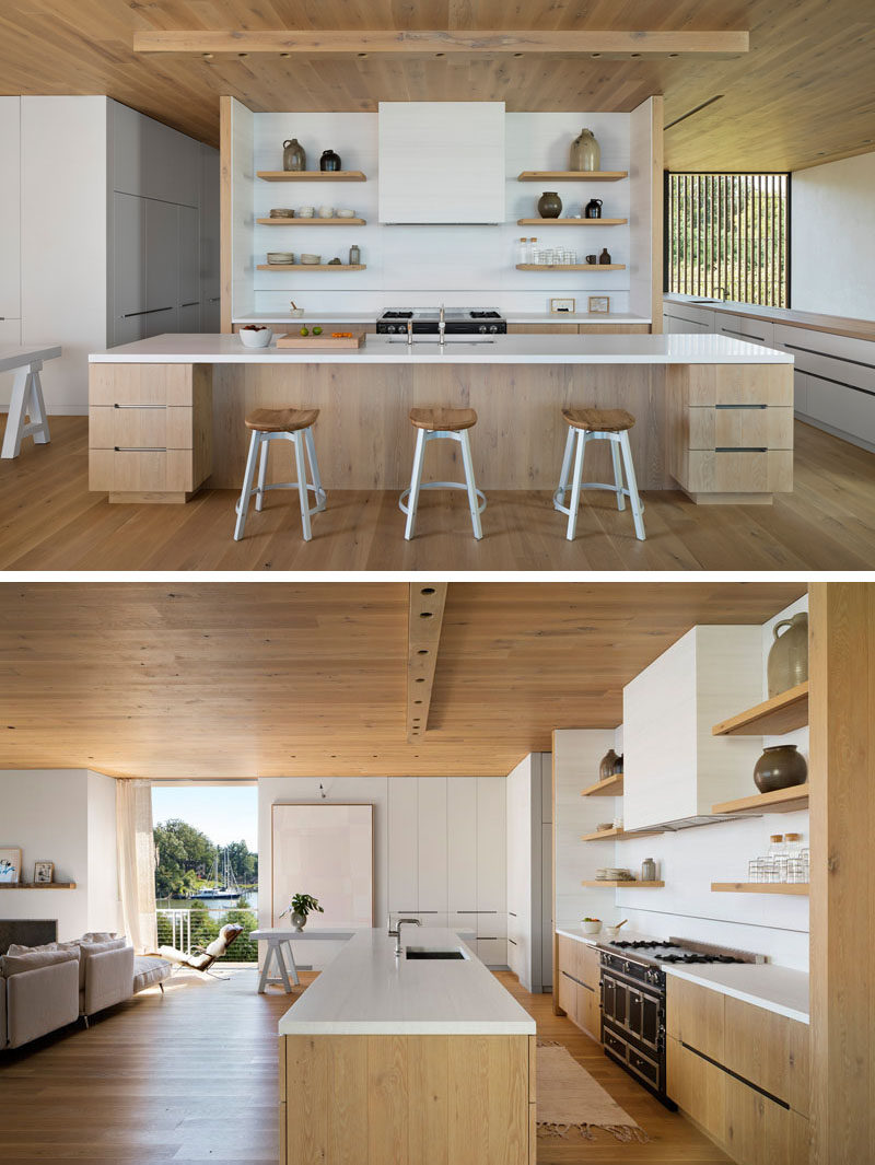 In this modern kitchen, white walls, cabinets, countertops, and furniture complement the surrounding wood, creating a calm and homey appearance. #ModernKitchen #WoodKitchen #WoodAndWhite