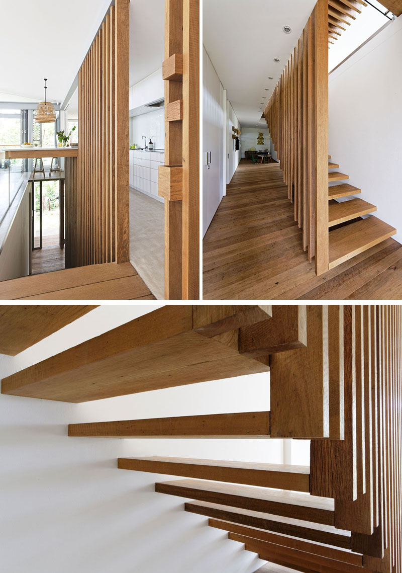 Tucked away between the living room and the kitchen in this modern house, are suspended wood stairs that lead down to the bedrooms. #SuspendedStairs #StairDesign #WoodStairs