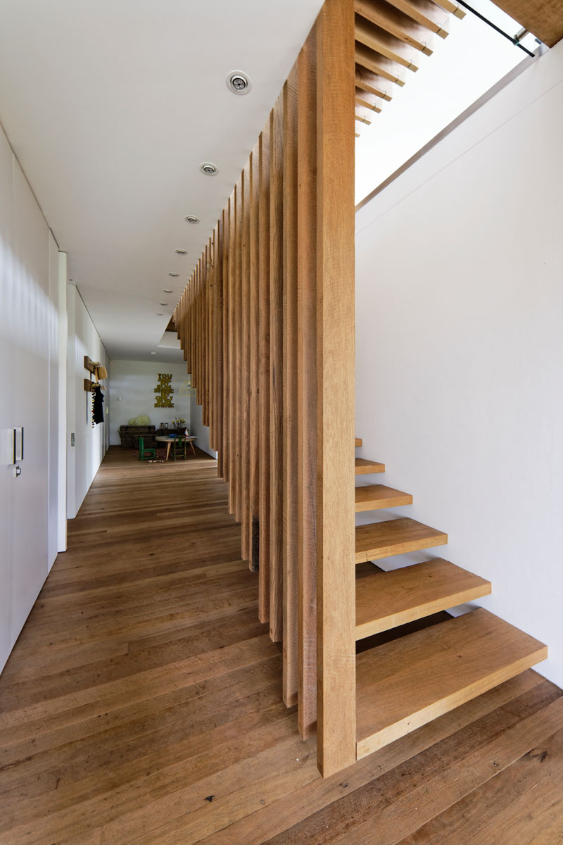 This modern house features suspended wood stairs that connect the living areas with the bedrooms below. #SuspendedStairs #WoodStairs #ModernStairs