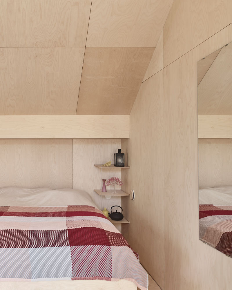 Windows filter the light through to the bright interior of this modern house that features birch plywood walls, ceiling, and floor. #PlywoodWalls #PlywoodInterior #Windows #Bedroom
