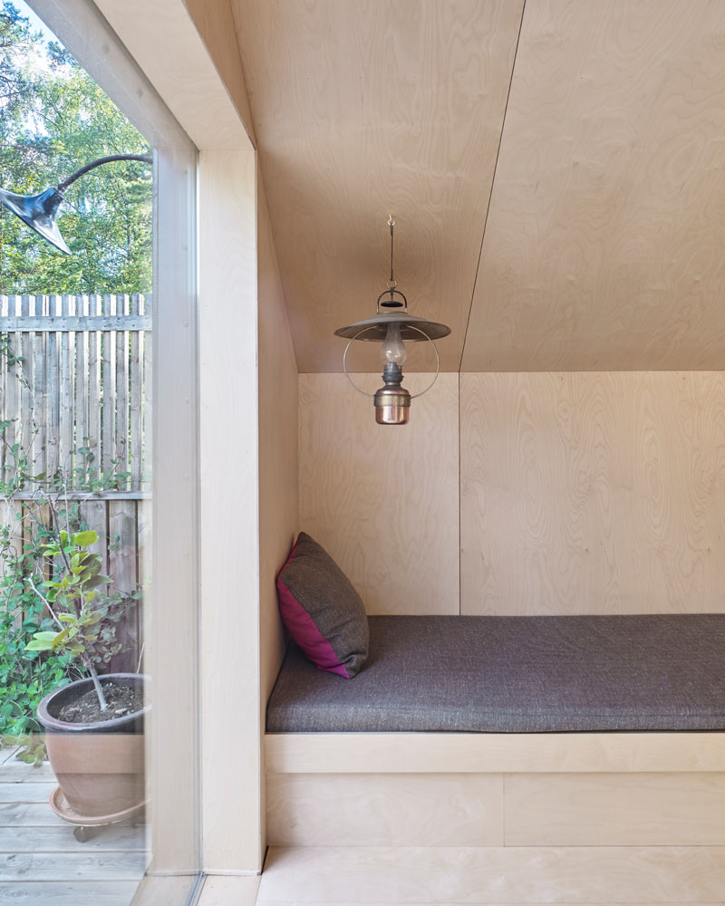 Windows filter the light through to the bright interior of this modern house that features birch plywood walls, ceiling, and floor. #PlywoodWalls #PlywoodInterior #Windows #Lounge