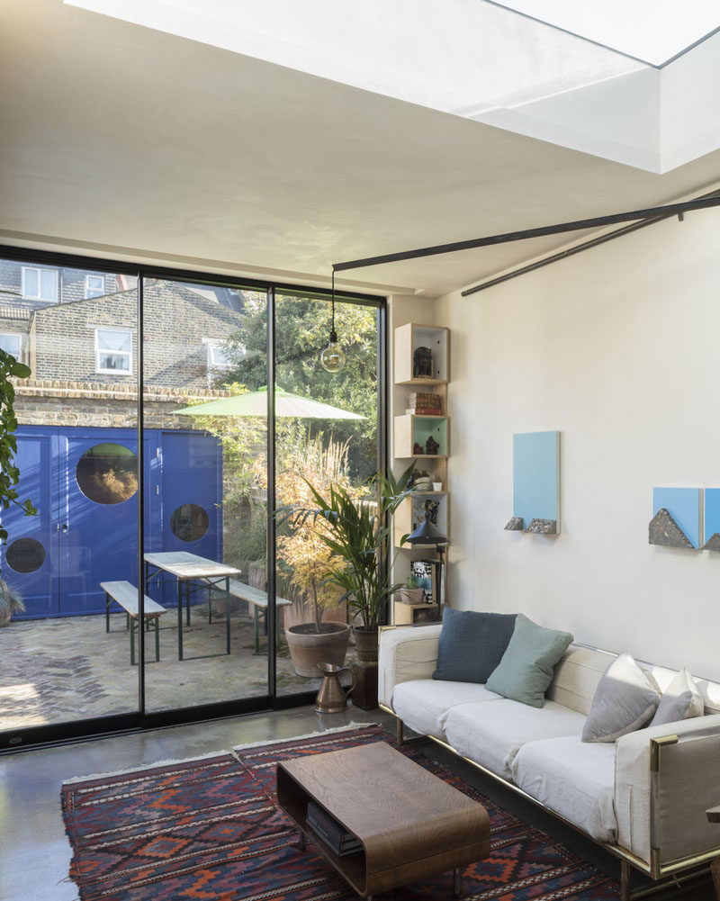 Floor-to-ceiling sliding doors open this living room to the patio outside, that provides additional living space and access to a small studio. #SlidingDoors #Patio #LivingRoom