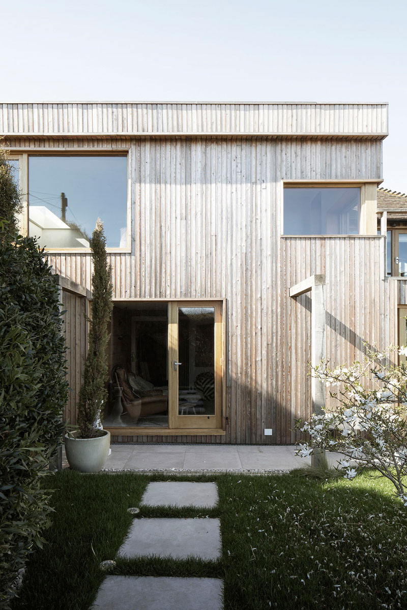 This contemporary house addition is covered in larch, a type of wood siding. #WoodSiding #TimberCladding #WoodExterior #WoodHouse