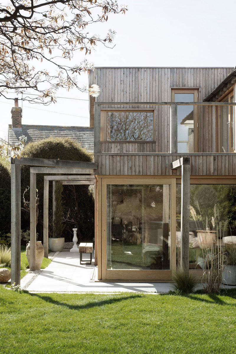 This contemporary house addition is covered in larch, a type of wood siding. #WoodSiding #TimberCladding #WoodExterior #WoodHouse