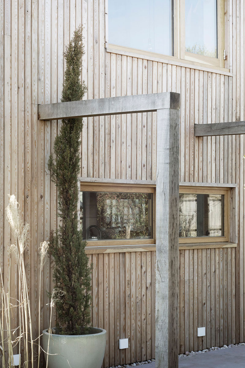 This contemporary house addition is covered in larch, a type of wood siding. #WoodSiding #TimberCladding #WoodExterior #WoodHouse