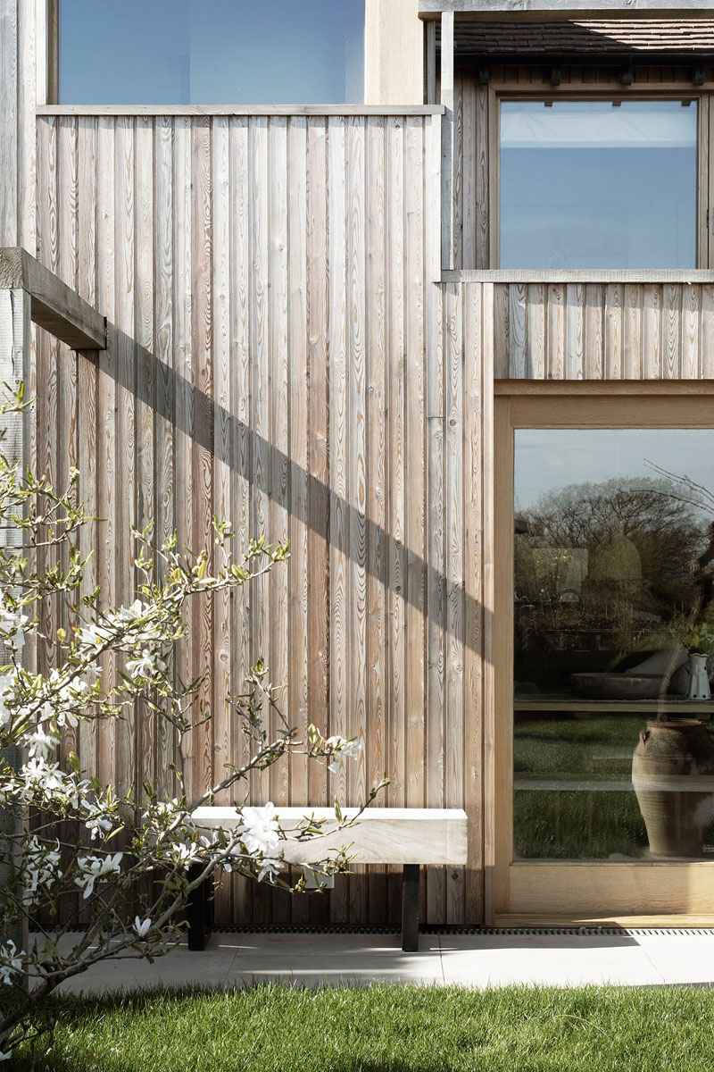 This contemporary house addition is covered in larch, a type of wood siding. #WoodSiding #TimberCladding #WoodExterior #WoodHouse