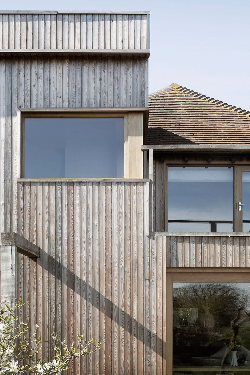 This contemporary house addition is covered in larch, a type of wood siding. #WoodSiding #TimberCladding #WoodExterior #WoodHouse