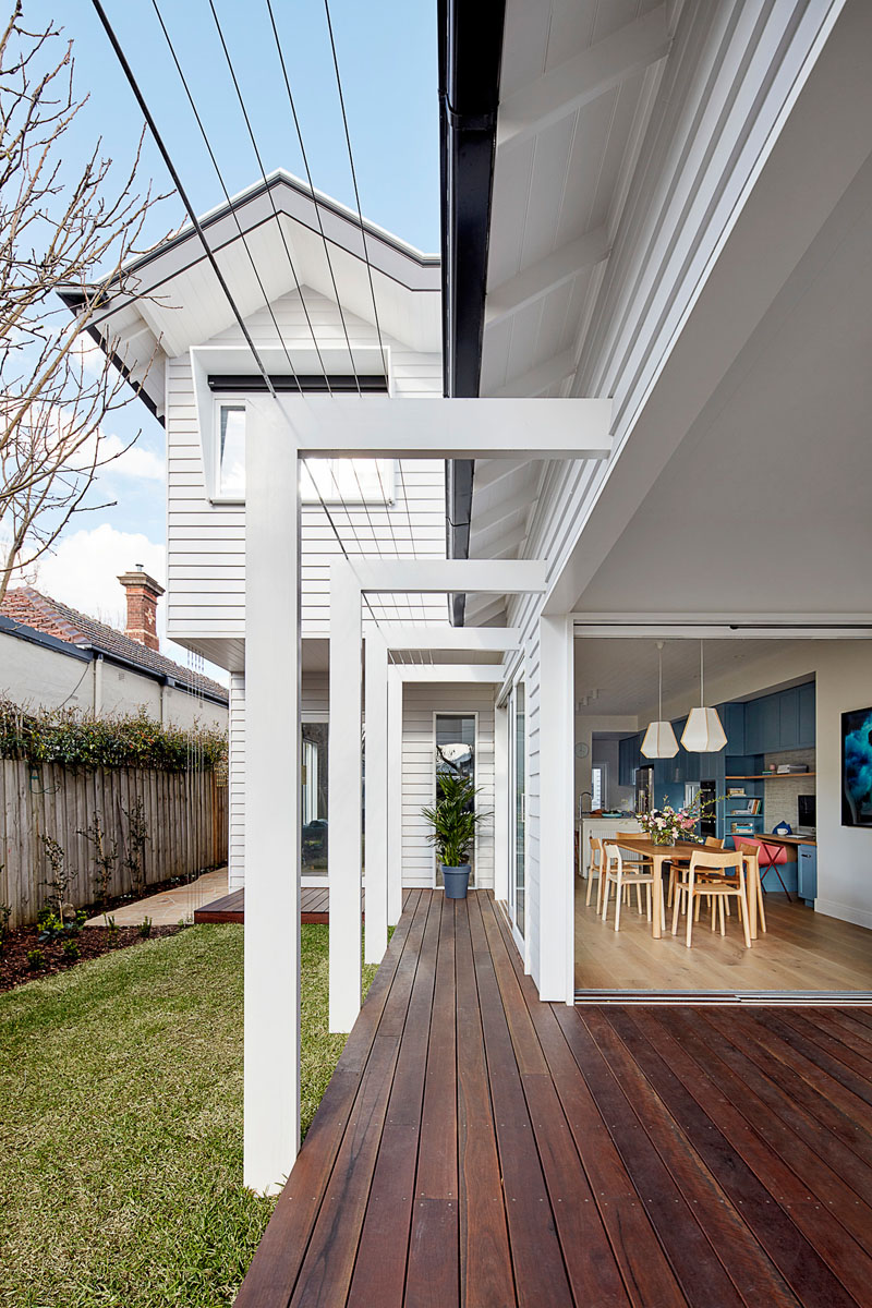 The dining room and the living room of this renovated house, both open up to the yard. A covered wood deck provides additional living space for the family. #Deck #Yard #Landscaping