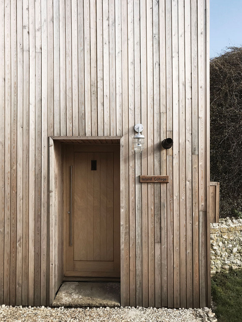 The exterior of this house addition is covered in larch siding, drawing inspiration from the surrounding coastal area. #LarchCladding #WoodSiding