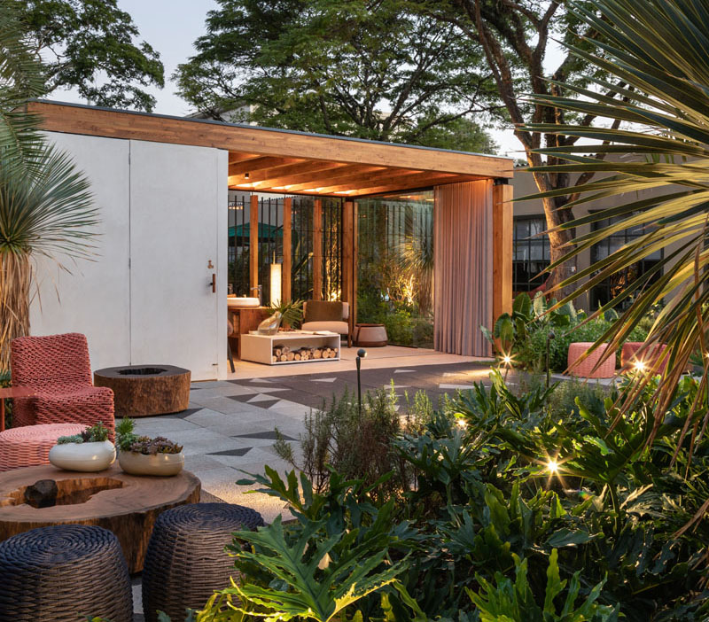 This modern outdoor terrace includes a wooden structure made from Brazilian pinus, wall coverings and flooring made of concrete, a toilet area, waiting lounge, and a counter with basins and a fireplace. #OutdoorTerrace #Terrace #Architecture #OutdoorSpace