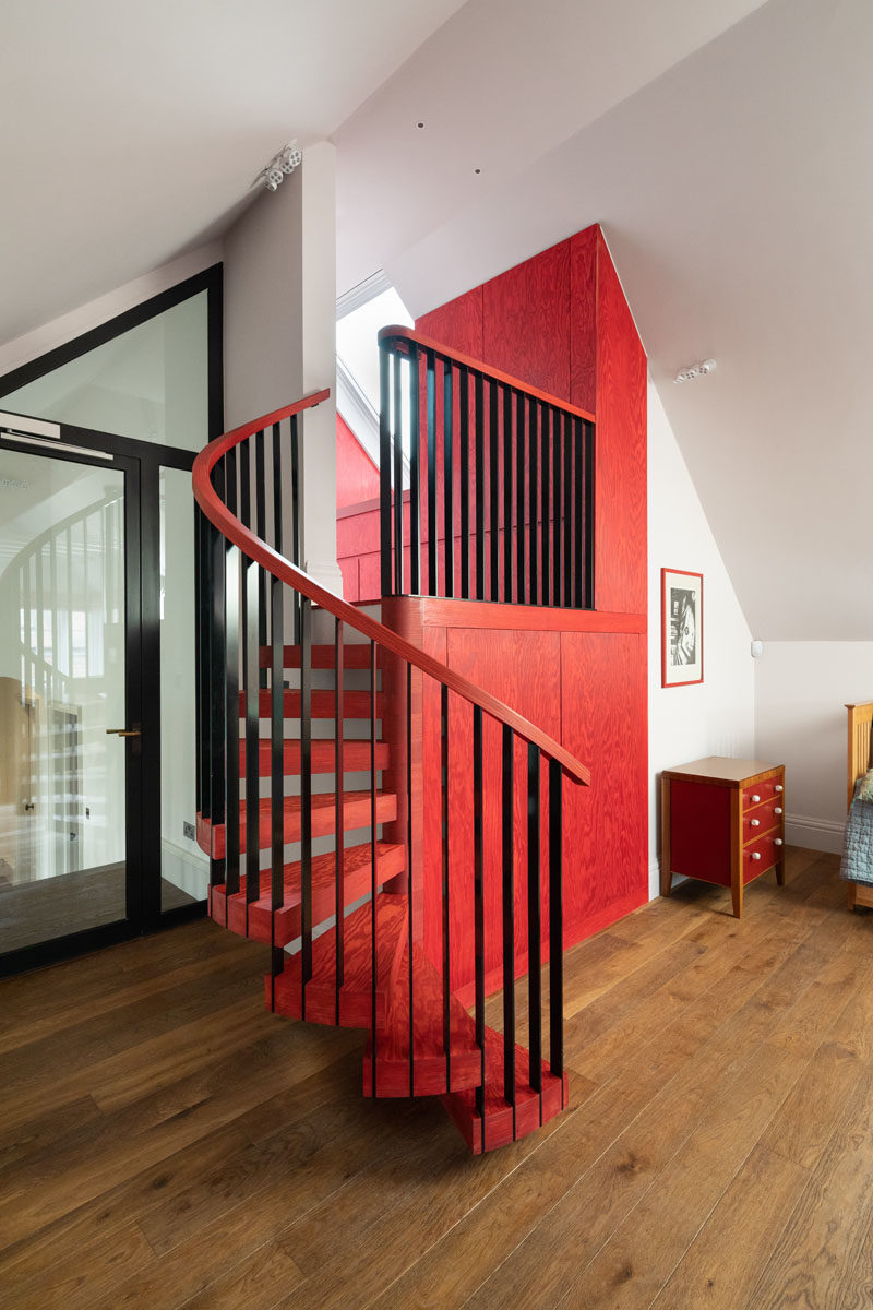 Stair Ideas - Red Linseed oiled Douglas Fir and custom ironmongery has been used to create built-in storage and spiral stairs that lead up to a matching bathroom. #SpiralStairs #RedCabinets #StairIdeas