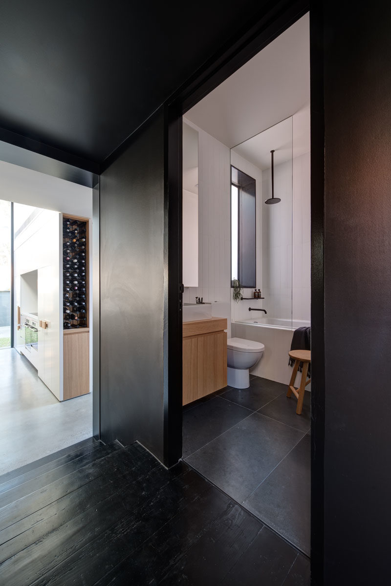 A dark section of this hallway has a matching door that reveals a hidden bathroom. #Hallway #BlackHallway