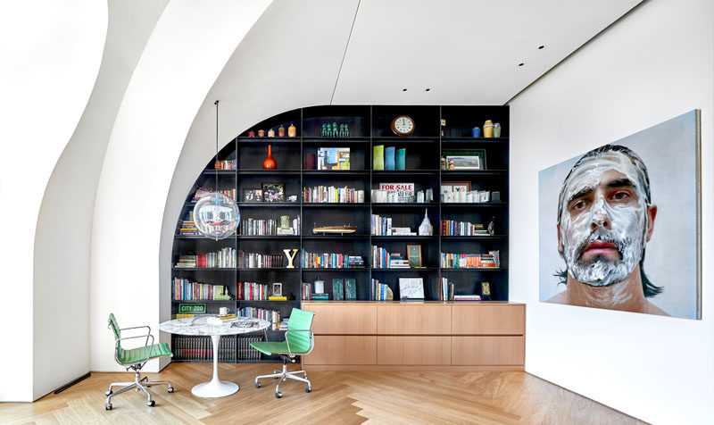 Shelving Ideas - This modern penthouse apartment features custom-designed steel shelving that follows the shape of the ceiling and wall. #Shelving #SteelShelving #Bookshelf