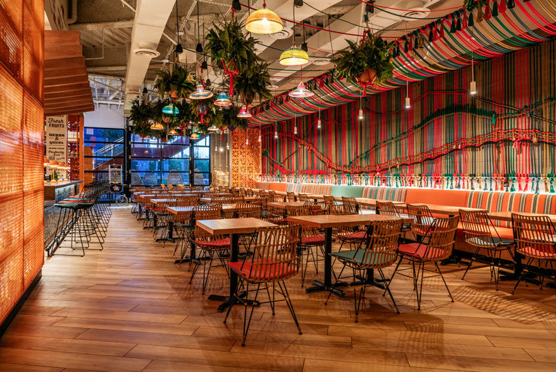 Restaurant Ideas - One of the main design elements in this new Miami restaurant, is a wall that's adorned with a multi-color handwoven macramé rope mural. #Mural #Art #RopeMural #Macrame #RestaurantIdeas