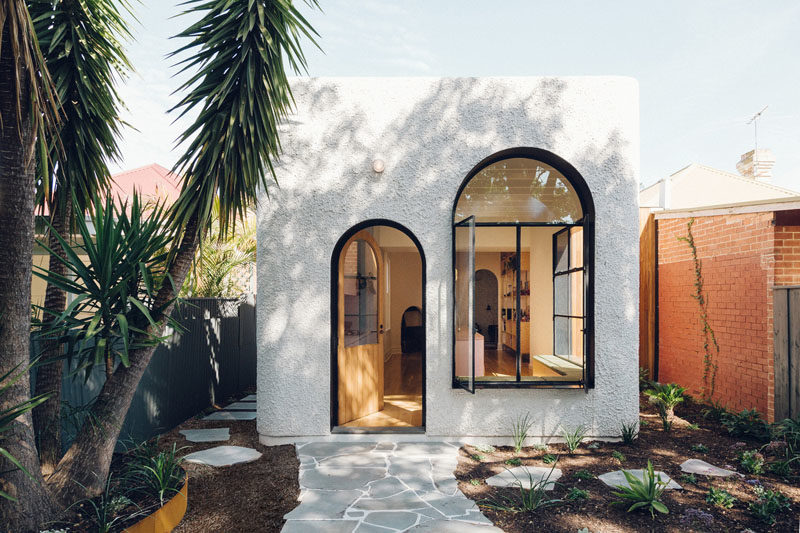 Window Ideas - This art-deco inspired house addition features black-lined deep window reveals, providing shade for the interior spaces, and adding a touch of drama to the white facade. #Windows #Doors #Architecture