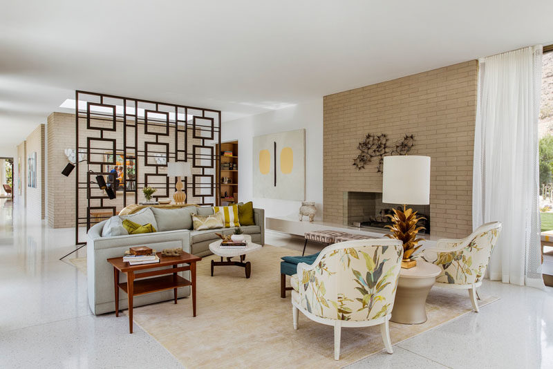 The living room in this renovated house has a new floor that features white terrazzo with amber accents that picks up the warmth of the earth tones found in the landscape surrounding the house. #Flooring #WhiteTerrazzo