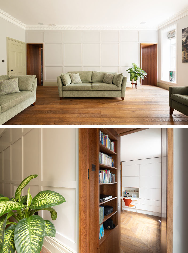 This updated living room features square edged wall paneling that helps to create a refined aesthetic and peaceful ambiance, and that also accentuates the Brown Oak doorways that have built-in bookcases, and lead through to the children’s playroom. #LivingRoom #PaneledWall #BuiltInBookshelf