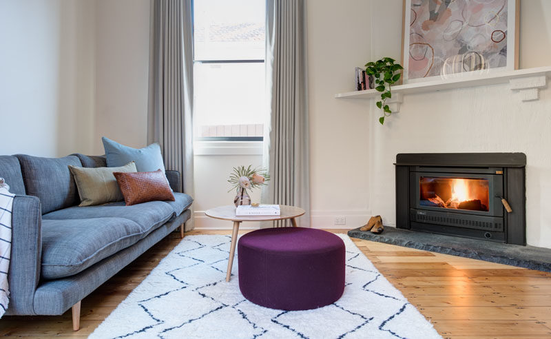 Living Room Ideas - This updated living room has an angled fireplace and a window that adds natural light. #LivingRoomIdeas #Fireplace