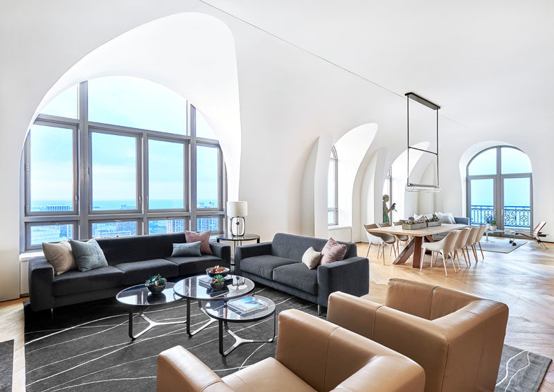 Arches in this modern penthouse offer dramatic space for the owner’s art collection and temper the impact of 14-foot ceilings.  #Arches #Architecture #Hallway #VaultedCeiling #HighCeilings #InteriorDesign