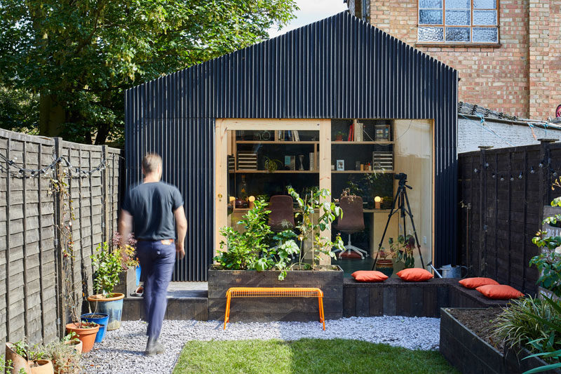 A small backyard office with room for two desks, and a bathroom.