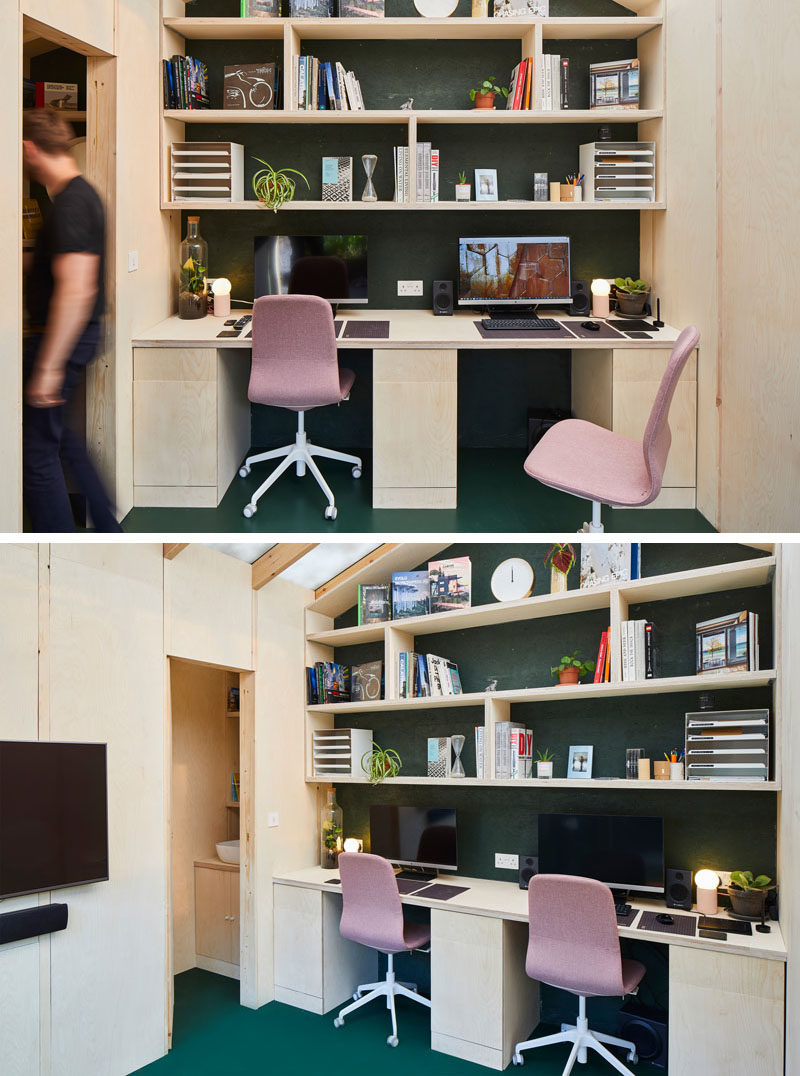A small backyard office with two desks, shelving, and a bathroom.