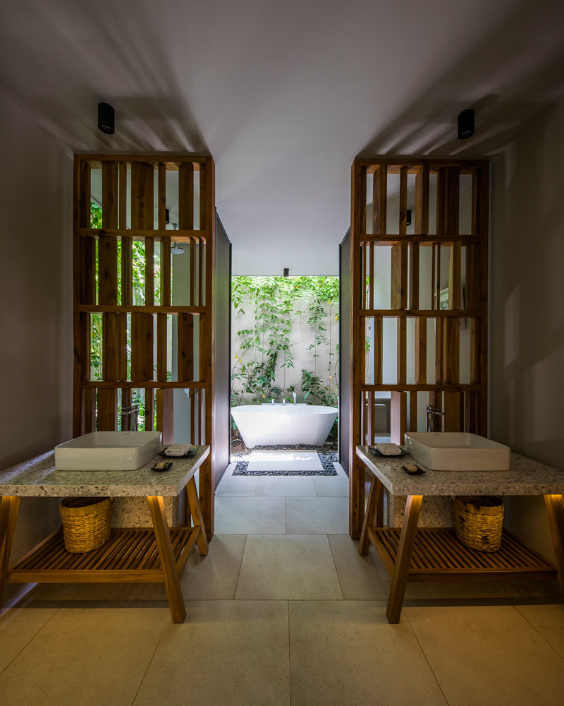 Bathroom Ideas - In this modern bathroom, two separate vanities perfectly frame the path to the outdoor bathtub. #BathroomIdeas #OutdoorBathtub