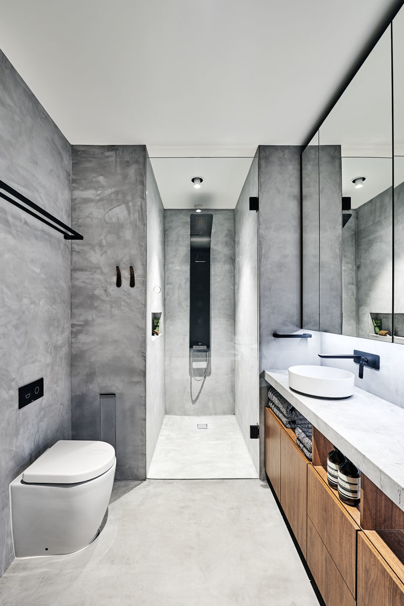 Bathroom Ideas - In this modern bathroom, grey walls have been accented with black, white, and wood elements. #BathroomIdeas #BathroomDesign #ModernBathroom