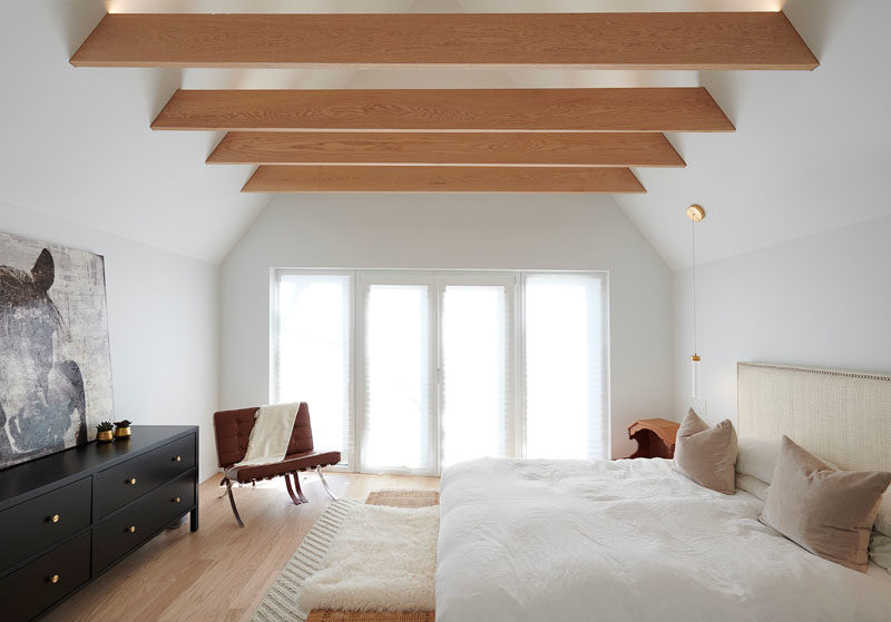 Bedroom Ideas - In the master bedroom, exposed wood beams draw the eye upwards to the height of the ceiling, making the room feel larger. #BedroomDesignIdeas #ExposedBeams #ModernBedroom