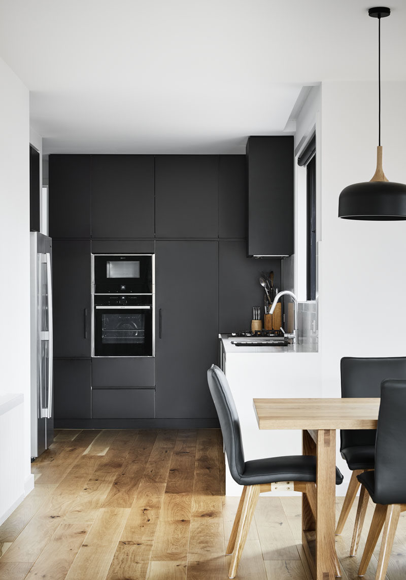 This modern kitchen features a combination of both matte black and white cabinets. #BlackKitchen #ModernKitchen #KitchenDesign