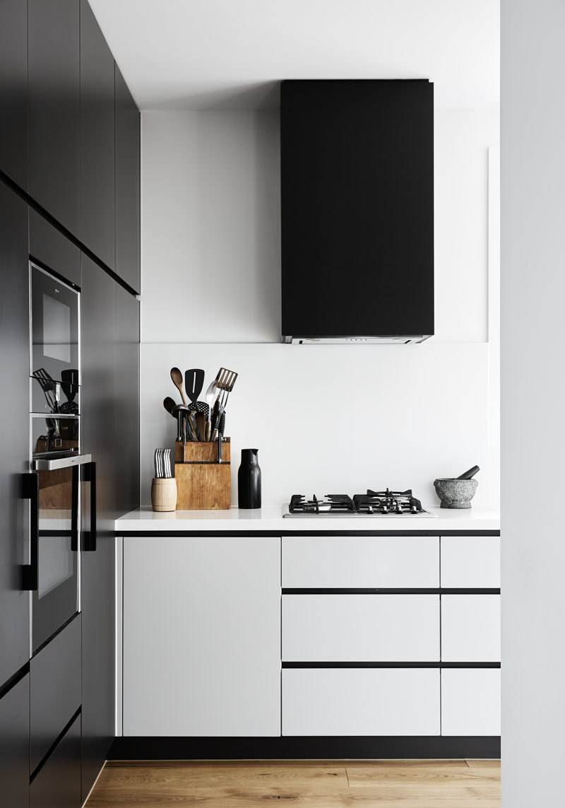This modern kitchen features a combination of both matte black and white cabinets. #BlackKitchen #ModernKitchen #KitchenDesign