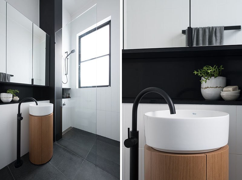 Bathroom Ideas - This modern bathroom has been designed with a minimalist pedestal sink, a walk-in shower, and black accents. #BathroomIdeas #BathroomDesign #ModernBathroom