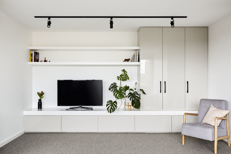 This modern rec room (rumpus room) has been designed with built-in cabinetry and open shelving. #RecRoom #RumpusRoom #Cabinets #Shelving