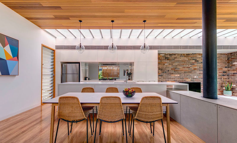 The high ceilings throughout this modern addition are timber lined, to ensure the space feels warm and inviting even in the large open rooms. #WoodCeilings #DiningRoom #ModernHouseAddition