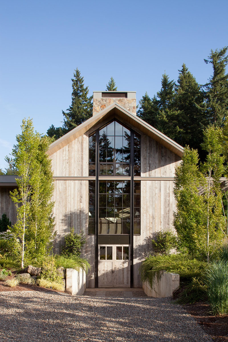 This house, which is reminiscent of a farm structure, is clad in reclaimed barnwood, and has a pitched roof with high windows at each end of the main volume, that flood the home with light. A green roof helps to create an emphasis on integrating the house into its natural surroundings.  #Architecture #FarmhouseModern #GreenRoof #ModernHouse #Landscaping #Windows