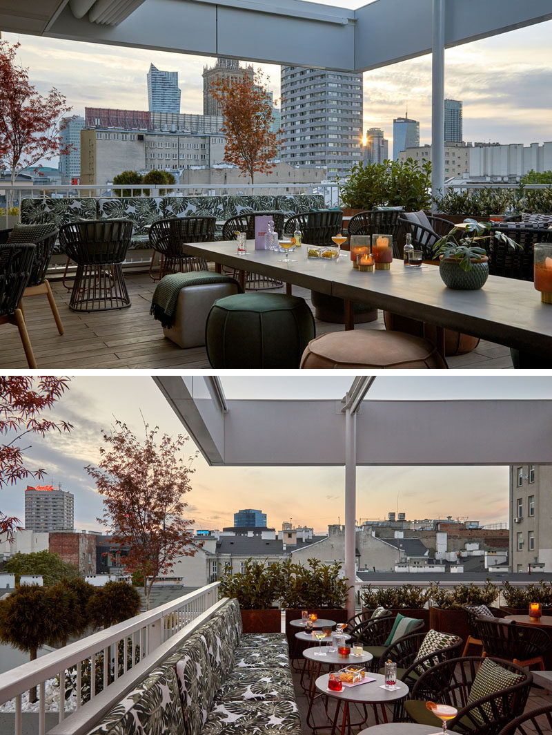 This modern rooftop cocktail bar has an almost tropical appearance, with leaf-print upholstery, wood flooring, and plants. #TropicalDesign #RooftopBar #Restaurant