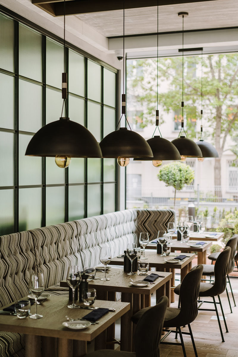 Restaurant Ideas - In this modern hotel restaurant, furnishings such as booths, banquette seating, and long communal wood tables, have been included to create a more rustic dining experience. #RestaurantIdeas #RestaurantDesign #InteriorDesign #Seating