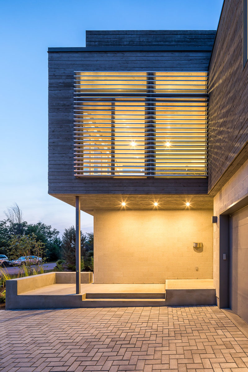 The exterior of this modern house showcases honed concrete-block walls and grey-stained cedar siding. #ModernHouse #ModernArchitecture #ConcreteBlockWalls #CedarSiding #GreyWood