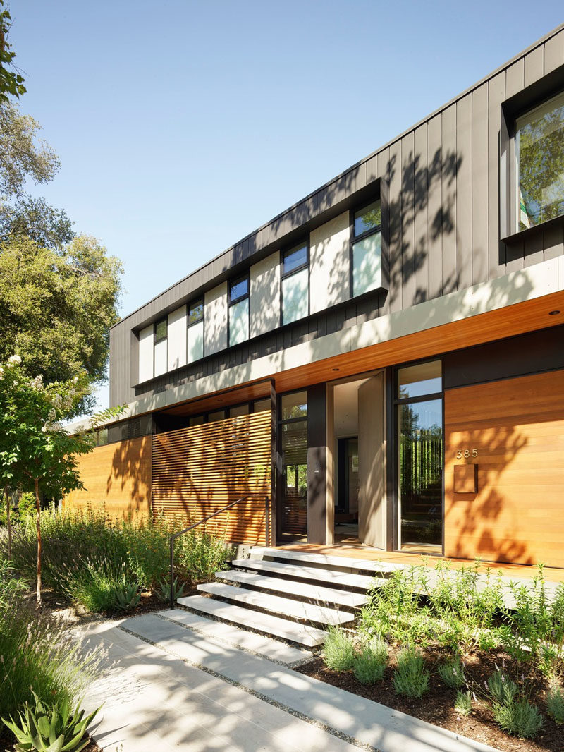 This modern house utilizes board formed concrete for the basement, cedar and larch siding for the main level, and dark panelized zinc for the top floor. #ModernHouse #HouseDesign #Architecture