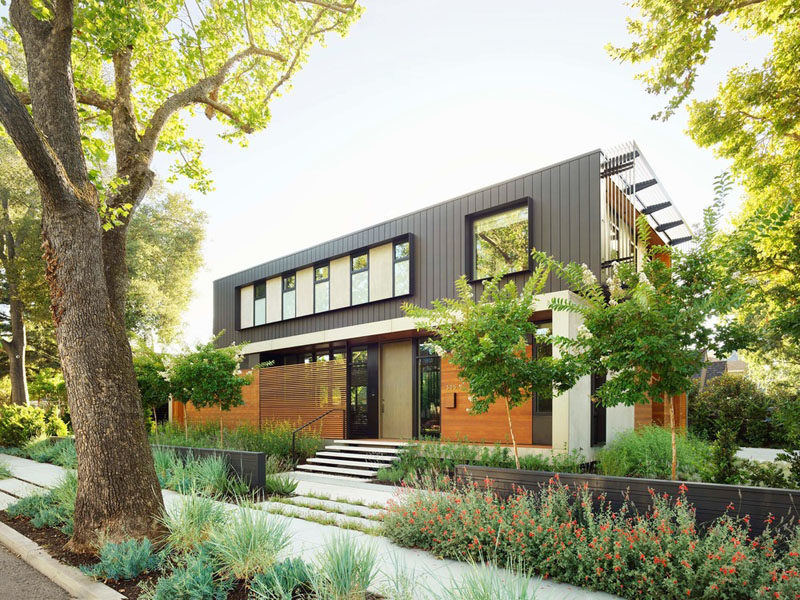 This modern house utilizes board formed concrete for the basement, cedar and larch siding for the main level, and dark panelized zinc for the top floor. #ModernHouse #HouseDesign #Architecture