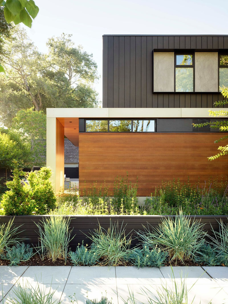 This modern house utilizes board formed concrete for the basement, cedar and larch siding for the main level, and dark panelized zinc for the top floor. #ModernHouse #HouseDesign #Architecture