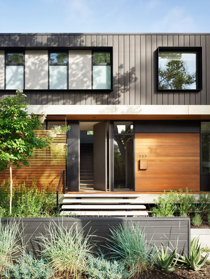 This modern house utilizes board formed concrete for the basement, cedar and larch siding for the main level, and dark panelized zinc for the top floor. #ModernHouse #HouseDesign #Architecture