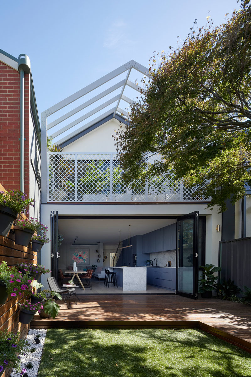 The gable roof form of this modern house addition was left over from a previous renovation in the 90's, however it was retained but extended over the balcony as a pergola to allow plants to eventually grow over and soften the facade. #Pergola #HouseAddition #Deck #Yard