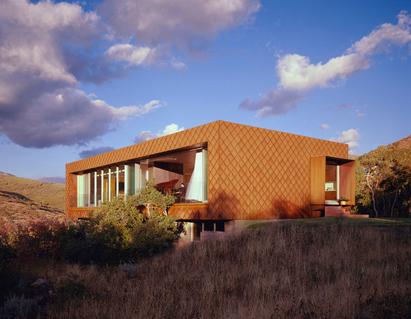 Siding Ideas - The warm colors of weathering steel cladding have been combined with board-formed wood textured concrete and glass for a contextual, low-maintenance and modern material palette for this house in Utah. #WeatheringSteelSiding #SidingIdeas #CortenSteel #Architecture