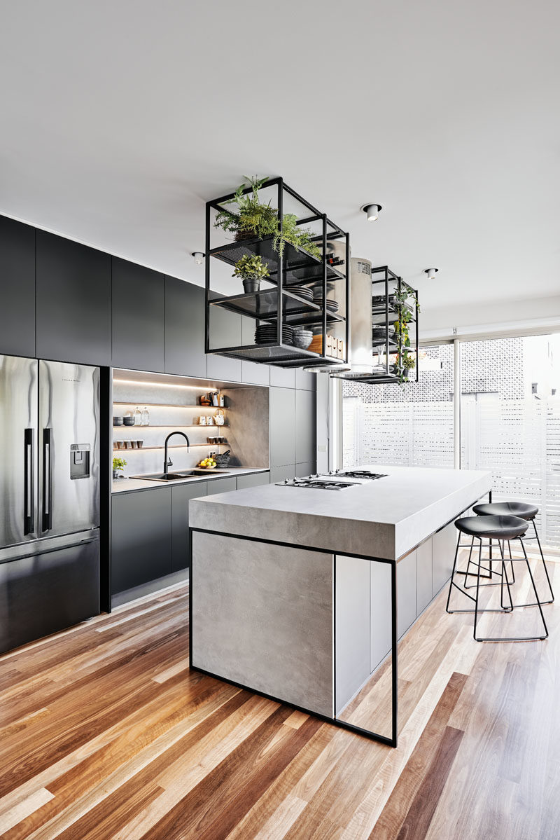 Kitchen Ideas - This modern kitchen serves as the food storage and prep area along with dining, a place for entertaining, and for now, it doubles up as the electronic hub station home office when required. #ModernKitchen #KitchenIdeas