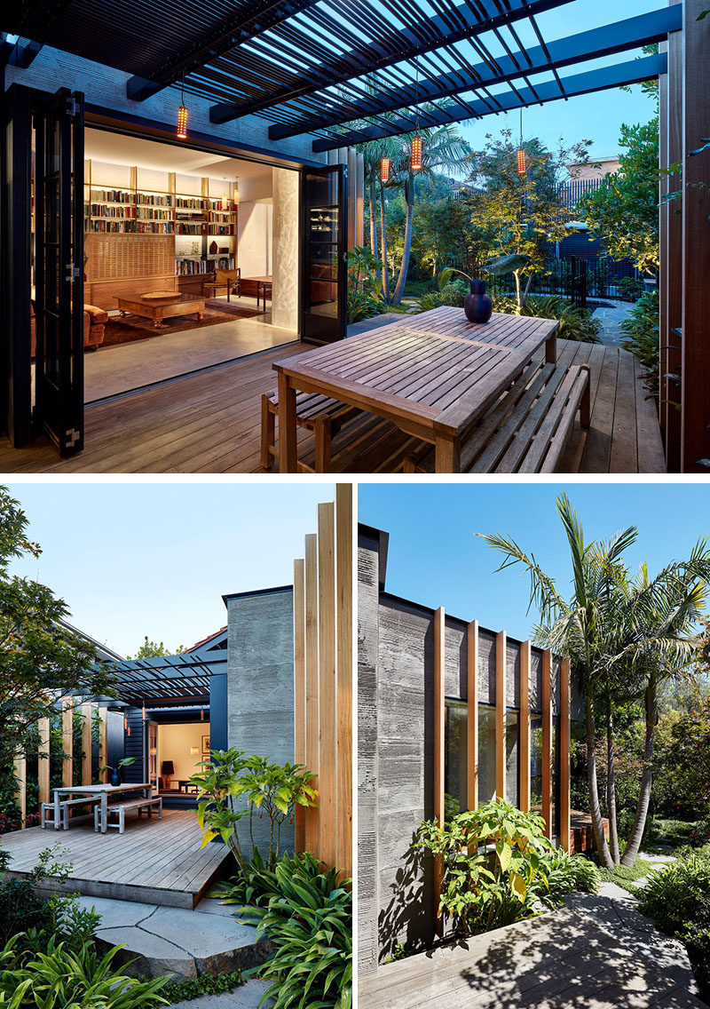 Folding glass doors open to a deck that expands the interior spaces of this modern house, creating an indoor / outdoor living area. #Deck #OutdoorDining #ModernPergola