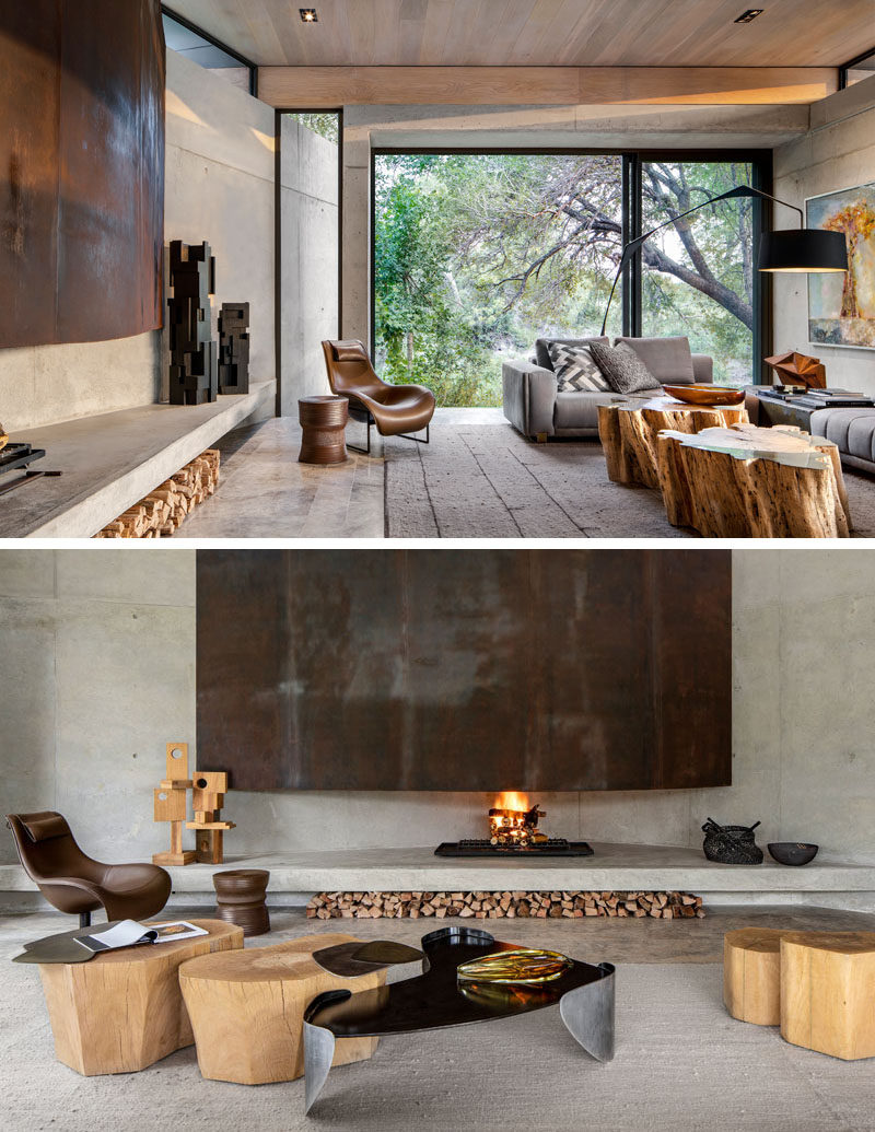 Fireplace Ideas - This modern living room has a large fireplace that showcases weathering steel, while space for firewood storage has been created underneath the concrete shelf. #Fireplace #FirewoodStorage #WeatheringSteel #ModernFireplace #FireplaceIdeas